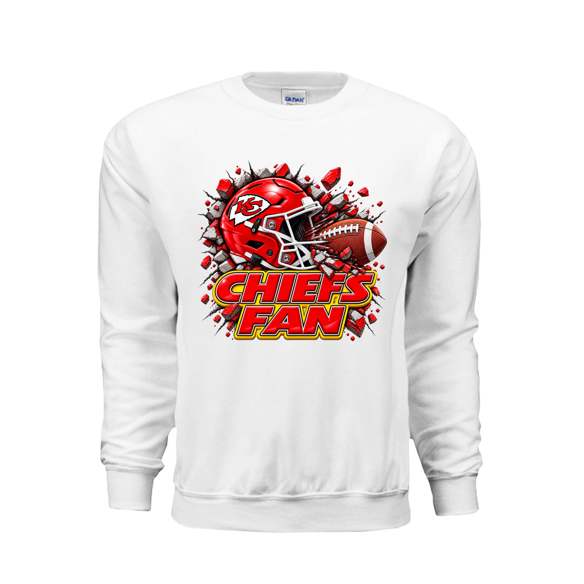 A White crewneck sweatshirt featuring a graphic of a red Kansas City Chiefs football helmet and a football bursting through red debris, with the text 'CHIEFS FAN' in red and yellow below. 